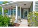 Inviting porch featuring rocking chair, potted plants, and decorative hanging baskets at 1589 Seabago Dr, Charleston, SC 29414