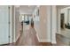 Long hallway with wood flooring leading to a living room and another room, creating an open, airy feel at 1589 Seabago Dr, Charleston, SC 29414