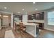 Open kitchen featuring dark wood cabinetry, granite countertops, and stainless steel appliances at 1589 Seabago Dr, Charleston, SC 29414