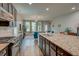 Featuring a spacious kitchen with granite countertops, an island with sink, and open to the living room at 1589 Seabago Dr, Charleston, SC 29414