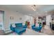 Open-concept living room with stylish blue seating, decorative rug, and an inviting atmosphere for relaxation and entertainment at 1589 Seabago Dr, Charleston, SC 29414