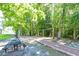 Park picnic area with swings and a picnic table surrounded by mature trees at 1589 Seabago Dr, Charleston, SC 29414