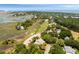 Scenic aerial view of the property overlooking a golf course and picturesque marshland at 16 Fairway Village Ln, Isle of Palms, SC 29451
