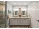 A bathroom featuring a double vanity, framed mirrors, and a glass shower with turquoise accents at 16 Fairway Village Ln, Isle of Palms, SC 29451