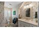 Bright bathroom with floral wallpaper, a single sink vanity, and a patterned rug at 16 Fairway Village Ln, Isle of Palms, SC 29451