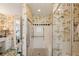 Bright bathroom with shower, tropical wall paper and seated bench at 16 Fairway Village Ln, Isle of Palms, SC 29451
