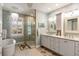 Bright bathroom featuring a soaking tub, glass shower, and dual vanities with coastal decor at 16 Fairway Village Ln, Isle of Palms, SC 29451