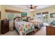 Cozy bedroom with two twin beds, ceiling fan, and bright natural light at 16 Fairway Village Ln, Isle of Palms, SC 29451