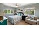 Cozy bedroom featuring a queen bed, matching nightstands, and views of the lush outdoors at 16 Fairway Village Ln, Isle of Palms, SC 29451