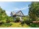 Charming two-story home featuring a screened-in porch surrounded by tropical landscaping at 16 Fairway Village Ln, Isle of Palms, SC 29451