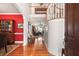 Bright foyer showcasing hardwood floors, a staircase, and an open view to the living area at 16 Fairway Village Ln, Isle of Palms, SC 29451