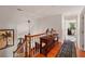 Hallway with hardwood floors, a wooden table with decor, and a staircase to upper level at 16 Fairway Village Ln, Isle of Palms, SC 29451