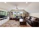 Spacious living room with leather sofas, patterned rug, and a view of the marsh at 16 Fairway Village Ln, Isle of Palms, SC 29451