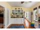 Office with wet bar featuring hardwood floors, white cabinetry, and granite countertops at 16 Fairway Village Ln, Isle of Palms, SC 29451