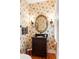 Charming powder room featuring unique botanical wallpaper, dark vanity, and stylish fixtures at 16 Fairway Village Ln, Isle of Palms, SC 29451