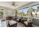 Comfortable sunroom with wicker furniture, ceiling fan, and large windows offering beautiful outdoor views at 16 Fairway Village Ln, Isle of Palms, SC 29451