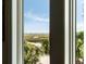 Beautiful marsh view from window with blue skies, vegetation, and water at 16 Fairway Village Ln, Isle of Palms, SC 29451