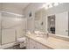 Bright bathroom featuring a glass shower door, stone vanity, and light fixtures above the mirror at 1600 Long Grove Dr # 1512, Mount Pleasant, SC 29464