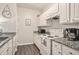 A kitchen featuring a sink, stove, microwave and a coffee maker with tiled countertops at 1600 Long Grove Dr # 1512, Mount Pleasant, SC 29464