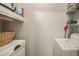The laundry room has a washer, a dryer and storage shelves above for convenience at 1600 Long Grove Dr # 1512, Mount Pleasant, SC 29464