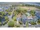 An aerial view displays beautiful homes with balconies, a community pool, and lush green landscaping at 1647 Marsh Harbor Ln, Mount Pleasant, SC 29464