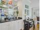 Elegant wet bar features mirrored shelving and granite countertops at 1647 Marsh Harbor Ln, Mount Pleasant, SC 29464