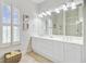 Bright bathroom with double vanity, shutters on window, lots of storage space, and natural light at 1647 Marsh Harbor Ln, Mount Pleasant, SC 29464