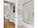 This bathroom has a tub shower combo with glass doors, and a hall area leading to another room at 1647 Marsh Harbor Ln, Mount Pleasant, SC 29464