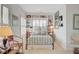 A quaint bedroom with built in bookcases, a wrought iron bed frame, and beach themed bedding at 1647 Marsh Harbor Ln, Mount Pleasant, SC 29464