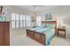 Bright bedroom with a wood frame bed, coastal bedding, plantation shutters, and a TV on the wall at 1647 Marsh Harbor Ln, Mount Pleasant, SC 29464