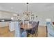 Open-concept dining area with hardwood floors, chandelier, and seamless access to the kitchen and living room at 1647 Marsh Harbor Ln, Mount Pleasant, SC 29464