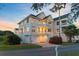 Charming three-story home featuring double balconies, an attached garage, and beautifully landscaped surroundings at 1647 Marsh Harbor Ln, Mount Pleasant, SC 29464