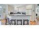 Bright kitchen features white cabinetry, dark countertops and bar seating at 1647 Marsh Harbor Ln, Mount Pleasant, SC 29464
