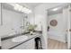 Modern bathroom with a sleek vanity, mirror, and ample lighting at 1705 Bassett Ct, Charleston, SC 29412