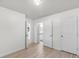 An empty bedroom showcasing new wood floors, neutral paint, and multiple doors at 1705 Bassett Ct, Charleston, SC 29412