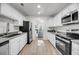 Bright kitchen features stainless steel appliances, white cabinetry, and a view into the living room at 1705 Bassett Ct, Charleston, SC 29412