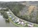 Aerial view captures lakeside homes with pools, roads, and surrounding lush forests and fields at 1713 Pimlico Blvd, Moncks Corner, SC 29461