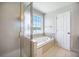 Bathroom featuring tiled floors, garden tub, and walk-in shower; natural light from the window at 1713 Pimlico Blvd, Moncks Corner, SC 29461