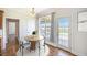 Bright dining area with round table, white chairs, and doors leading to the outdoor deck and waterfront view at 1713 Pimlico Blvd, Moncks Corner, SC 29461