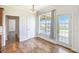 Bright dining area with hardwood floors and large windows overlooking the backyard and water at 1713 Pimlico Blvd, Moncks Corner, SC 29461