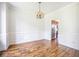 Open-concept dining room with a chandelier and wainscoting, flowing into the adjacent kitchen at 1713 Pimlico Blvd, Moncks Corner, SC 29461