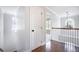 Hallway with hardwood floors and view of an arched window and chandelier at 1713 Pimlico Blvd, Moncks Corner, SC 29461