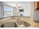 Kitchen sink with granite countertop and view of the living room with fireplace at 1713 Pimlico Blvd, Moncks Corner, SC 29461