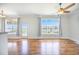 Open-concept living room with a ceiling fan, hardwood floors and large windows overlooking the waterfront view at 1713 Pimlico Blvd, Moncks Corner, SC 29461