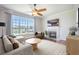 Cozy living room featuring a fireplace, ceiling fan, and a large window with a waterfront view at 1713 Pimlico Blvd, Moncks Corner, SC 29461