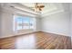 Bright main bedroom features tray ceilings, wood-look floors, and large window overlooking the water at 1713 Pimlico Blvd, Moncks Corner, SC 29461