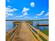Picturesque wooden pier extends into the lake on a sunny day with scattered clouds and a blue sky at 1713 Pimlico Blvd, Moncks Corner, SC 29461