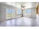 Bright sunroom featuring a ceiling fan, glass doors, and large windows with views of the outdoor scenery at 1713 Pimlico Blvd, Moncks Corner, SC 29461