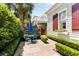 Beautiful backyard with seating area surrounded by manicured greenery and palm trees at 18 Fernandina St, Mount Pleasant, SC 29464