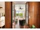 Inviting covered balcony with seating and views of the waterway through open wood paneled doors at 18 Fernandina St, Mount Pleasant, SC 29464